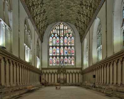 The inside of the Chapter House, showing the stained glass windows and ornate ceiling.